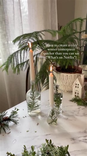Dawnalee | Easy Recipe + Decor Ideas for Every Celebration on Instagram: "🎄Comment MERRY and I’ll teach you how to create memorable moments this holiday season without the overwhelm. One of my favorite ways to add winter hygge (pronounced HEW-guh), which means a cozy sense of being, to a corner of our home or table is by adding water and snippets of greens from the backyard to clear, recycled bottles and top with a taper! There’s just nothing like the warmth of candlelight. 🕯 Creating a magica
