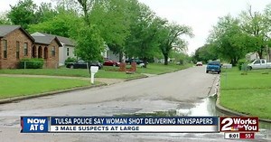 Woman shot while delivering newspapers