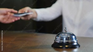 Modern luxury hotel reception counter desk with bell. Female guest calling on silver hotel bell on wooden stand and getting chip key from room. Hotel visitor arriving. Travelling. tourism business. 4