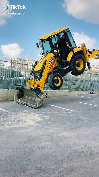 Backhoe Loader Stunt Show in Outdoor Parking Lot