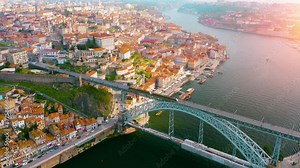 Porto, Portugal, aerial view of old town and Dom Luis Bridge over the Douro river. Beautiful architecture of Porto with red roofed, old buildings.