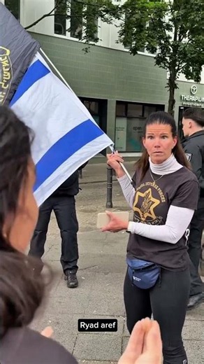 During a demonstration in support of Gaza’s civilians, a supporter confronted a woman carrying