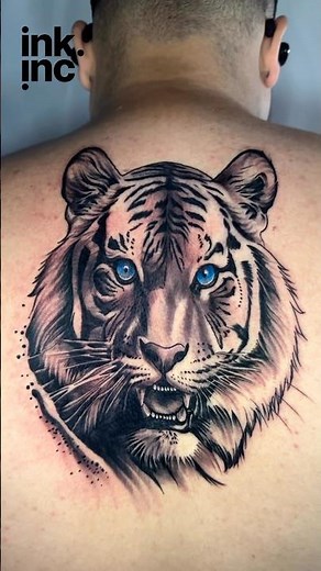 Realistic Tiger Face Tattoo with Striking Blue Eyes on Upper Back #tattoo#tattooideas