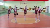 Slow motion locked down footage of five beautiful cheerleader girls...