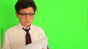 Portraitof a school boy thinking, solving a problem on chroma key green screen background