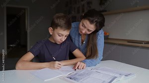 Mom and adult son teach homework at home, mom helps son do homework, sister helps teach lessons to teenager, study at home, beautiful mom and handsome adult son study at home