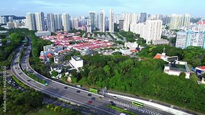 Aerial 4k footage of Singapore city skyline with residential buildings and cars during bright sunny day.