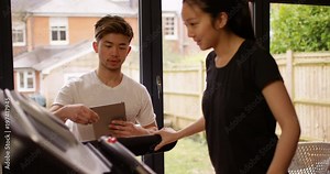 4K Fitness instructor adjusting treadmill settings for his female client at the gym