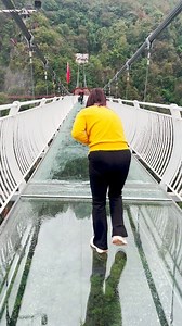 Sweeping water away from the breathtaking glass bridge that connects two majestic mountains! This transparent bridge, designed for thrill-seekers, offers stunning views from every angle. As the mist and droplets are cleared away, the excitement of standing on this architectural marvel, suspended high above the landscape, becomes even more exhilarating. An unforgettable adventure for those who love a rush of adrenaline mixed with scenic beauty! | Asian Technology