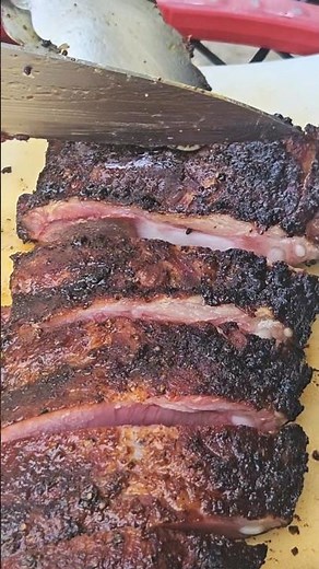 Cutting Juicy smoked Spare Ribs