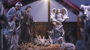 Jesus Christ Nativity scene with figurines in stable and light particles. Jesus Christ birth in a manger with Mary and Joseph. Christmas scene. Dolly shot 4k Stock Video