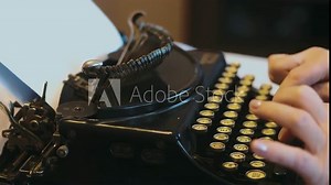 Professional video of senior woman typing on an old typewriter in 4k slow motion 60fps