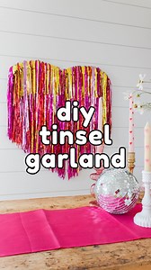 A DIY tinsel garland heart for Valentine’s Day? We love to see it. 💘💖💗 INSTRUCTIONS To make the heart, cut a 9-gauge craft wire to about 46 inches. Then, bend the middle of the wire to create a point and smooth out both sides for the top of the heart. Next, fold some tinsel garland over the wire and tape it down around the wire. Then, repeat it in a different color. Trim each piece so it is shorter than the last one. Then, attach the oversized heart to the wall. Attach smaller sections of the