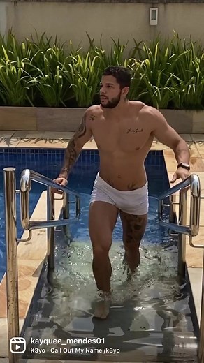 Man Exiting Pool in Stylish Summer Setting