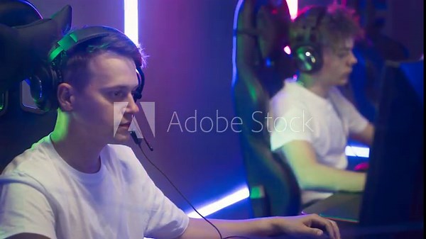 Boy Gamer Loses Round In E-Sport Team Competition At Cyber Arena With RGB Lights. Boy Gamer In Audio Headset Playing Internet Cybersport Competition. Boy Feels Challenge Of Gamer Competition
