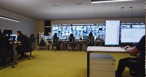 Security control room operators at work in high end security surveillance facility Stock Video