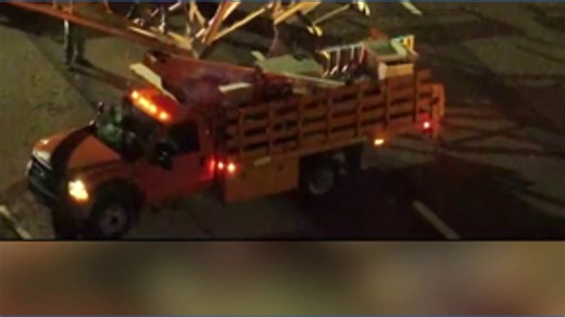 Crumpled sign closes four lane highway