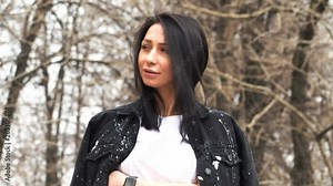 Beautiful girl outdoors posing in front of the camera.