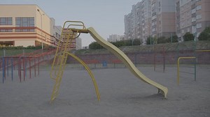 clip-3446546433-children-slide-on-playground-horizontal-bars-sandy