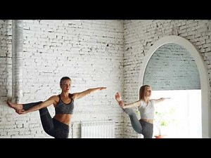 Attractive young girl is having individual yoga practice with professional instructor and doing