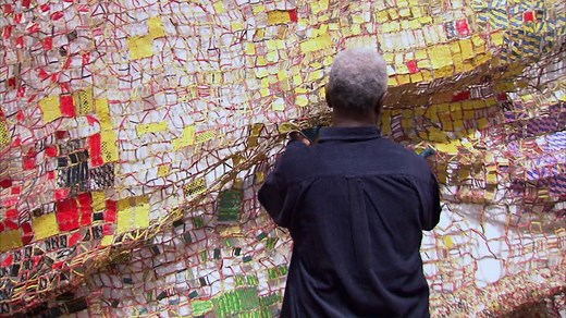 Working with caps from liquor bottles, El Anatsui creates densely patterned sculptures that trace a broader narrative around colonial economic exchange and slave trade in Africa. "When the European traders came to Africa for the first time, drinks were exchanged for slaves, who were brought to America to grow more cotton and sugar cane to make more drink and then ship to Europe," says the artist in our "Change" episode. "So, the idea of three continents, and how drink was a link factor between t