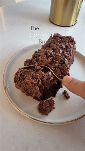 Crumbssss on Instagram: "You’ve tried our viral crunch cake - now meet the brownie version. Deep chocolate, soft centre, irristable crunch. #viralcrunch #crumbssssbakery #blackburn #brownie #feuilletine"