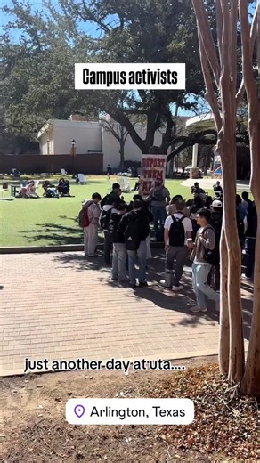 Dallas Fingerprint | Two man seen on campus at UT-Arlington yesterday, one holding a “Deport them all” sign and one giving a speech. | Instagram
