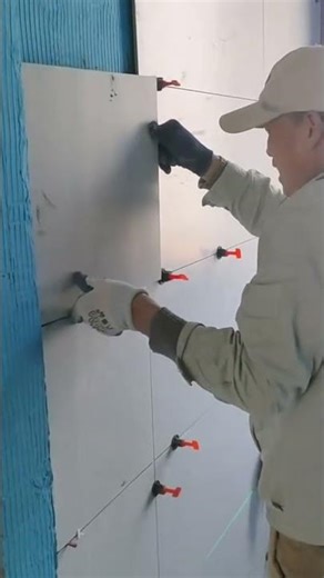 the process of installing ceramic tiles on the walls in the bathroom of the house #construction