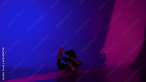 Adult woman dancer dancing in leather bra and high heels in the studio, blue and pink neon light vibrant background.