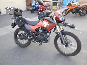 1.2K views · 46 reactions | CSC TT250, GREAT BIKE TO ADD ACCESSORIES. RX3 rear luggage, Wolfman Soft Bags,RX3 Headlight Guard, 10W Spot Lights,Aluminum Skid Plate, Wolfman Fender Bag, Tank Bag. ONLY A FEW LEFT FOR $2195.00 DELIVERED TO YOUR DOOR. | CSC Motorcycles | Facebook