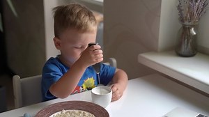 Child Whipping Milk In A Glass