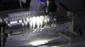 Metalworking CNC milling lathe machine for metal cutting tool processing steel metal spiral pinion or worm screw shaft in workshop. Machine for grooving into roll calibers, processing of metal parts