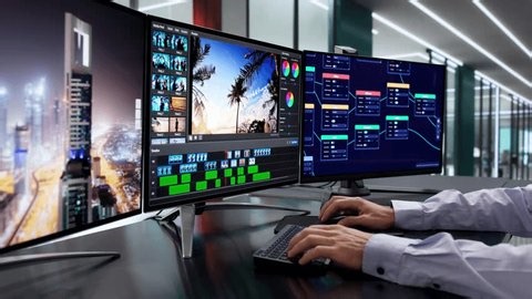 clip-3976789009-man-editing-video-on-computer-using-modern