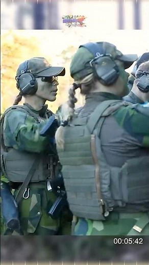 U.S. Marines with Swedish Female Army Soldiers, conduct a simulated raid target
