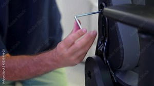 Male repairman repairing office chair. Furniture repair and assembly concept. Caucasian man hands screw chair back. Assembling office chair indoors
