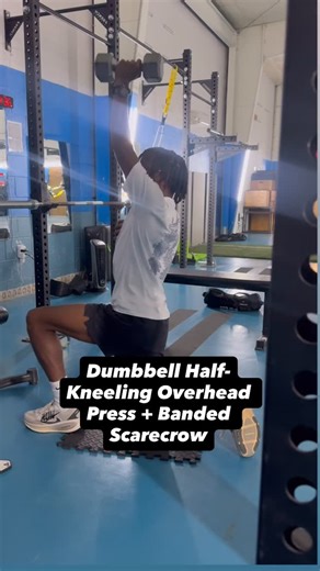 Coach Bruce on Instagram: "Dumbbell Half-Kneeling Overhead Press + Banded Scarecrow Purpose / Why we use it (Train Fit style): This combo locks in core stability, shoulder integrity, and scapular control while pressing overhead. The half-kneeling position eliminates lower-body cheating and forces true anti-extension and anti-rotation control—huge for athletes. #TrainFitPerformance #ShoulderHealth #OverheadStrength #AthleteTraining #ScapularControl #RotatorCuffWork #CoreStability #UnilateralTrain