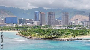 4K aerial overview of Honolulu Downtown. Modern frontline business and residential buildings on Oahu. Expensive apartments in the skyscrapers with scenic Pacific ocean beach view on Hawaii island, USA