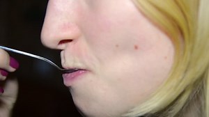 beautiful blonde girl eats cake closeup