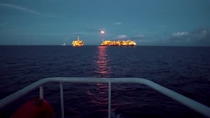 FPSO Tanker Vessel Near Oil Rig Platform. Offshore Oil and Gas Industry