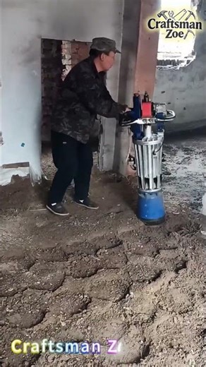 Workers operate small compactors indoors