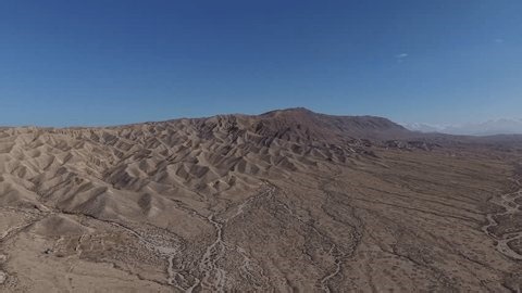 clip-3988318577-majestic-push-in-shot-circling-jagged-eroded-badlands