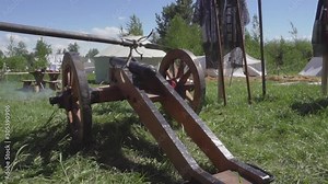 Realistic real medieval cannon shooting in the open air. Slow motion footage.