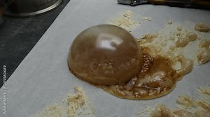 During the process of making cannabis concentrate, BHO or butane hash oil, a very large bubble of wax forms on the parchment paper.