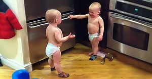 Twin baby boys having a conversation.