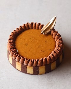 It turns out a striped tart shell is far too time-consuming 😅 This is filled with a marbled hazelnut cake, passionfruit cream and milk chocolate ganache. I used a chocolate cremeux to pipe a delicate border then filled the centre with a hazelnut praline! | Matt Adlard