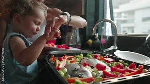 Mother teaches her little son how to cook healthy food in the kitchen. Lifestyle with caucasian people in single parent family. Child helps mother at kitchen.