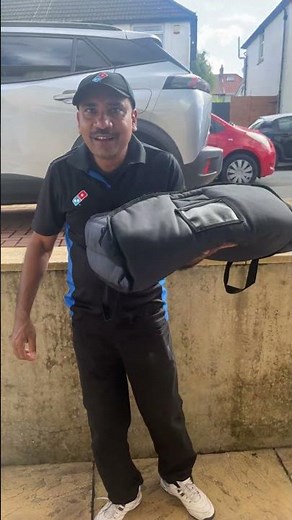 Domino’s delivery man sings along in Newport, England, UK