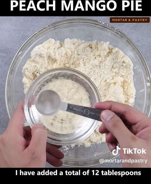 Peach Mango Pie | Homemade Baked Peach Mango Pie Recipe #mango #peachmango #peachmangopie #recipe #pie #dessert #fyp #fypシ Ingredients: For the filling: 500g canned peaches, cut into cubes 500g ripe mangoes, cut into cubes 1/4 cup sugar 1/4 cup cornstarch For the crust: 4 cups all purpose flour 1/3 cup sugar 1 teaspoon baking powder 1/2 teaspoon salt 1 cup (225g) cold butter 8 to 12 tablespoons ice cold water Egg wash for brushing: 1 egg yolk 2 tablespoons milk 1 teaspoon sugar pinch of salt *Ba