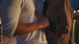 Closeup couple hands connecting on evening date. Loving man gently touching girl