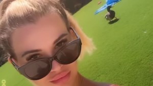 Christine McGuinness looks stunning in sexy pink bikini as she parades in garden